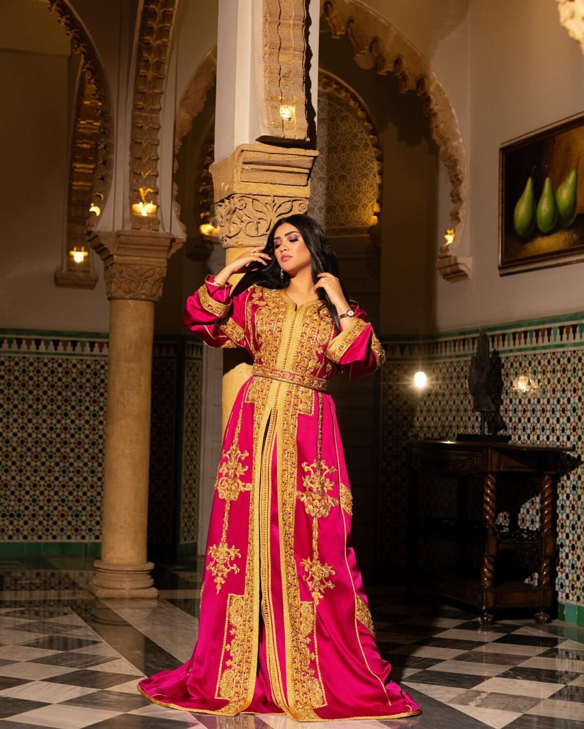 Caftan Market Place Découvrez l'élégance intemporelle du caftan henna, une pièce traditionnelle marocaine magnifiquement ornée. Nos caftans en henna allient beauté et tradition pour des moments inoubliables. Explorez notre collection unique aujourd'hui ! Le caftan Nariman se compose de deux pièces en satin duchesse rose, ornées de broderies dorées, de perles en cristal, de sfifa et de boutons en skali doré. La partie inférieure est confectionnée en drap de soie rose, perlé à la main. Il est accompagné d'une ceinture assortie en métal.