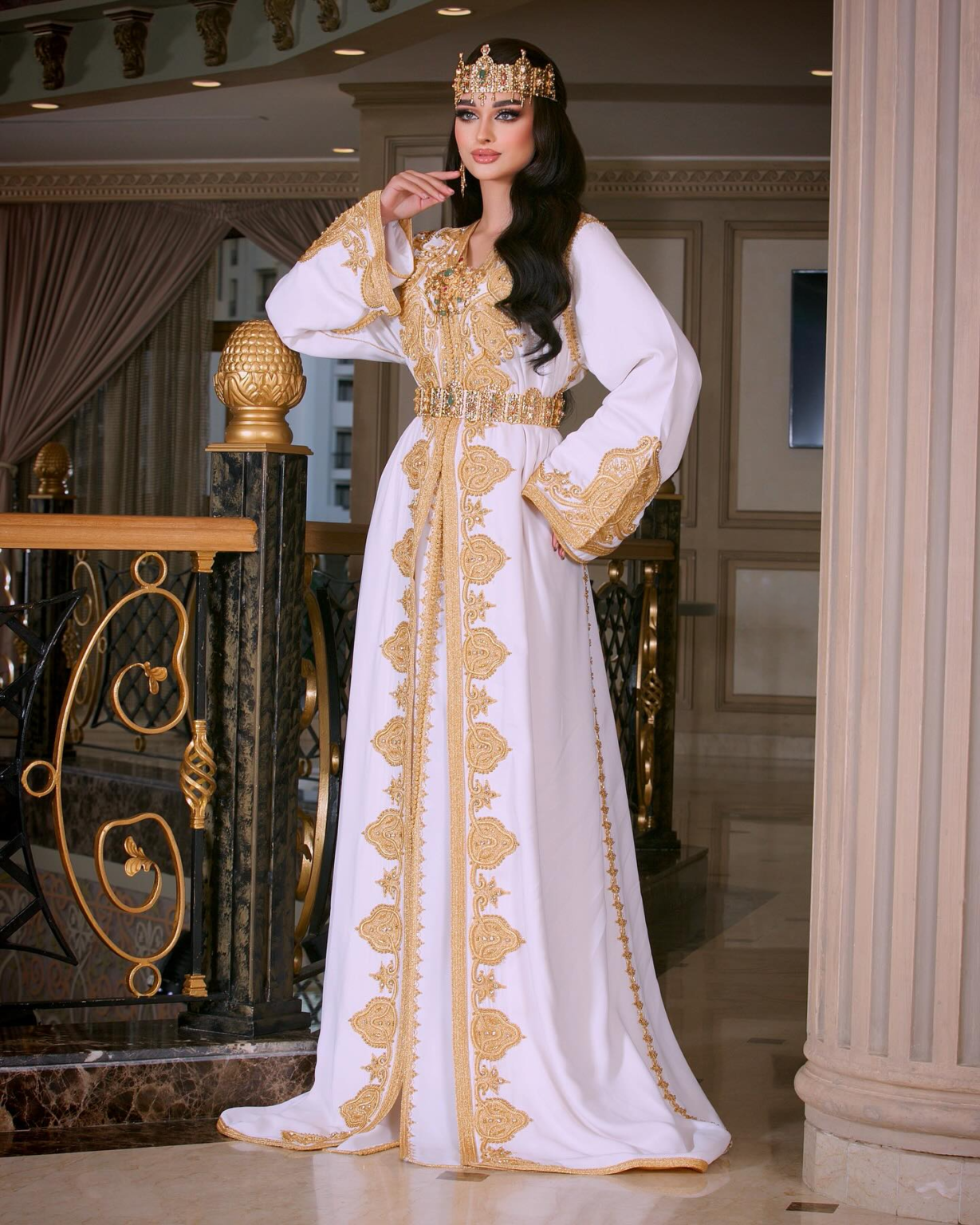 CAFTAN EXPORT Découvrez l'élégance intemporelle du caftan henna, une pièce traditionnelle marocaine magnifiquement ornée. Nos caftans en henna allient beauté et tradition pour des moments inoubliables. Explorez notre collection unique aujourd'hui ! Le caftan sirene, composé de deux pièces en crêpe de soie blanc, travaillé en zewak maalam, sfifa et button en skali doré. Le bas est confectionné en draps de soie blanc, Il est accompagné d'une ceinture assortie en metal.